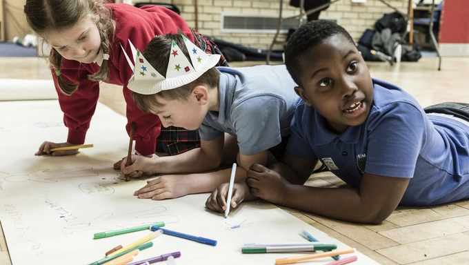 Military Kids Club Heroes drawing together on the floor Children at a Military Kids Club Heroes drawing together on the floor.