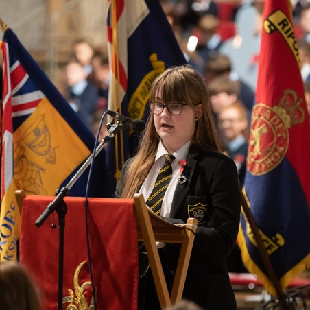 Young girl giving a speech at Ripon Cathedral for Remembrance 2018