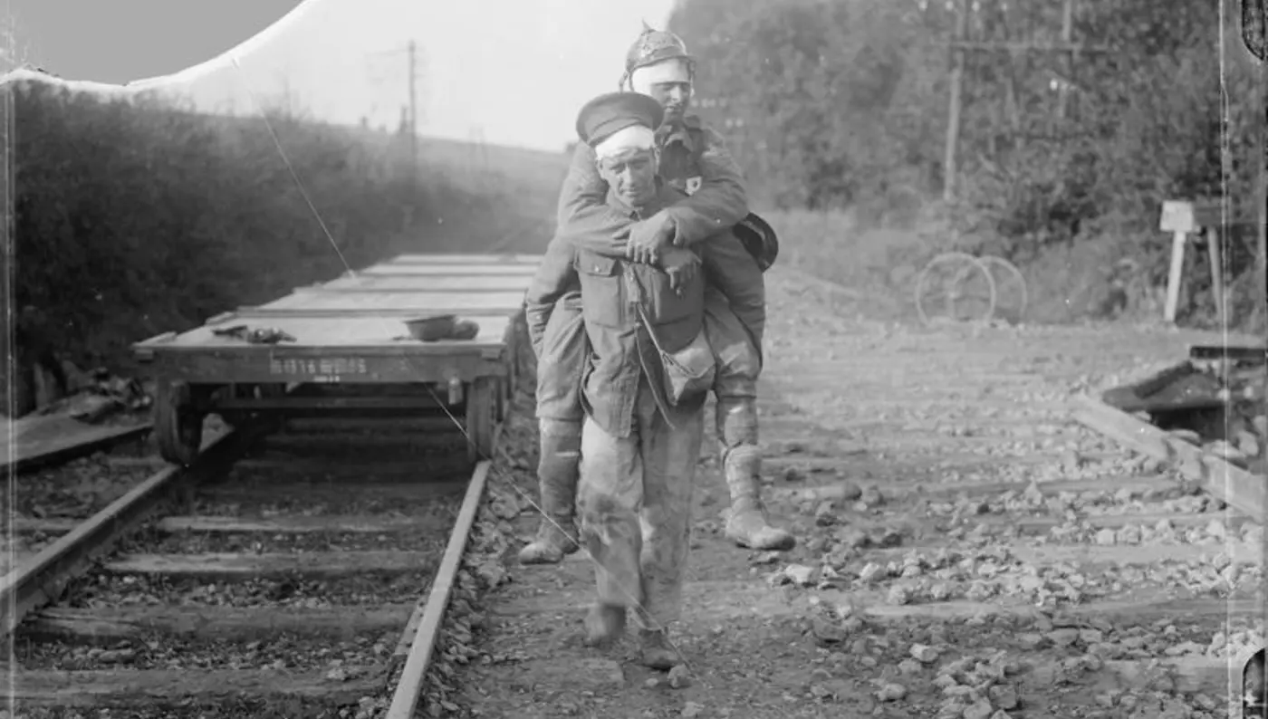 Soldier carrying wounded by Ernest Brooks Soldier carrying a wounded man