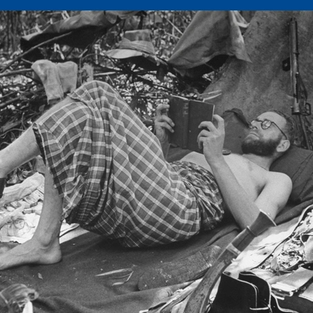 British soldier reading for relaxation at jungle base during WWII Burma campaign