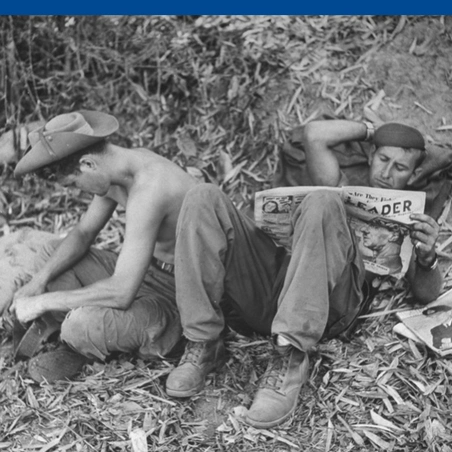 British soldier reading "Leader" for relaxation at jungle base during Burma campaign