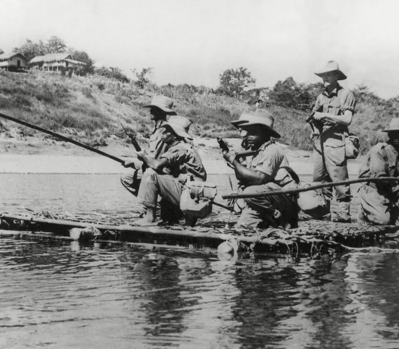 West African troops navigate a stretch of the Kaladan River on a raft