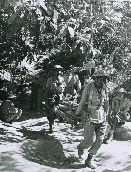 A wounded British soldier being evacuated by Indian Army stretcher bearers, Burma