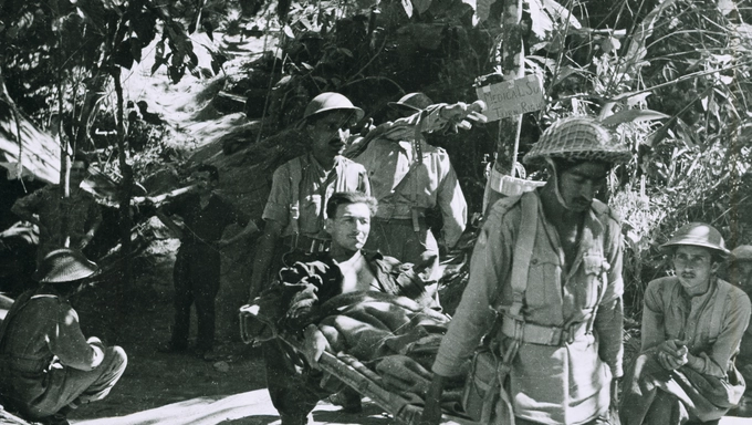 A wounded British soldier being evacuated by Indian Army stretcher bearers, Burma