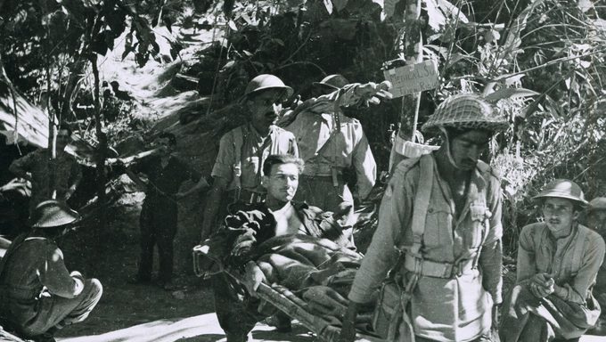 NAM_50591 A wounded British soldier being evacuated by Indian Army stretcher bearers, Burma