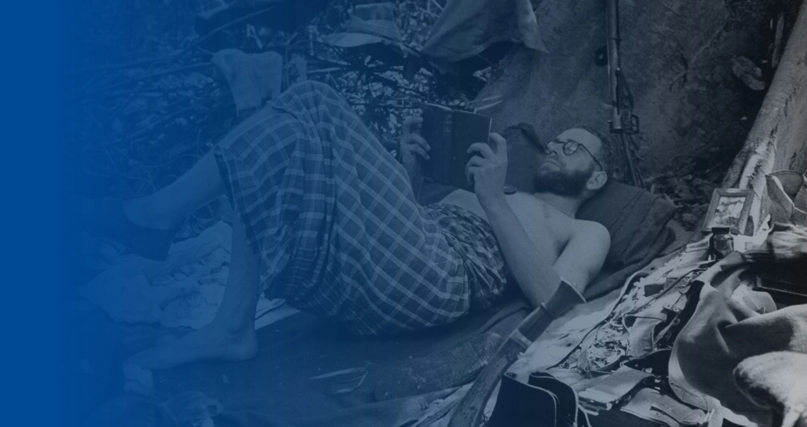 British soldier reading for relaxation at jungle base during WWII Burma campaign