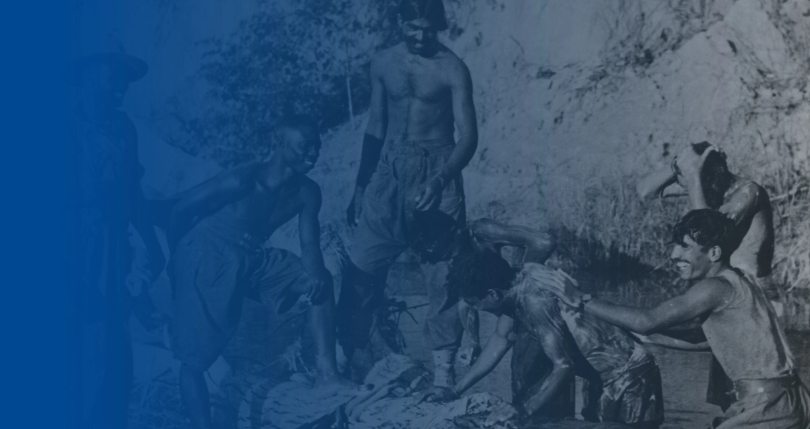 West African and Indian troops bathing in a stream
