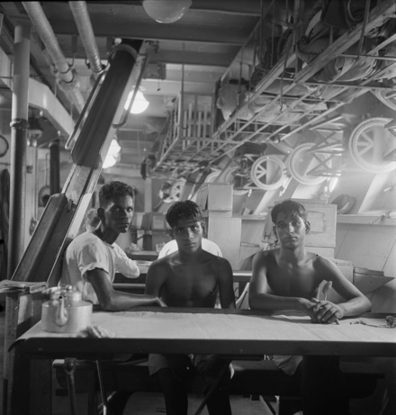 Three Indian stokers on the mess deck of HMIS SUTLEJ