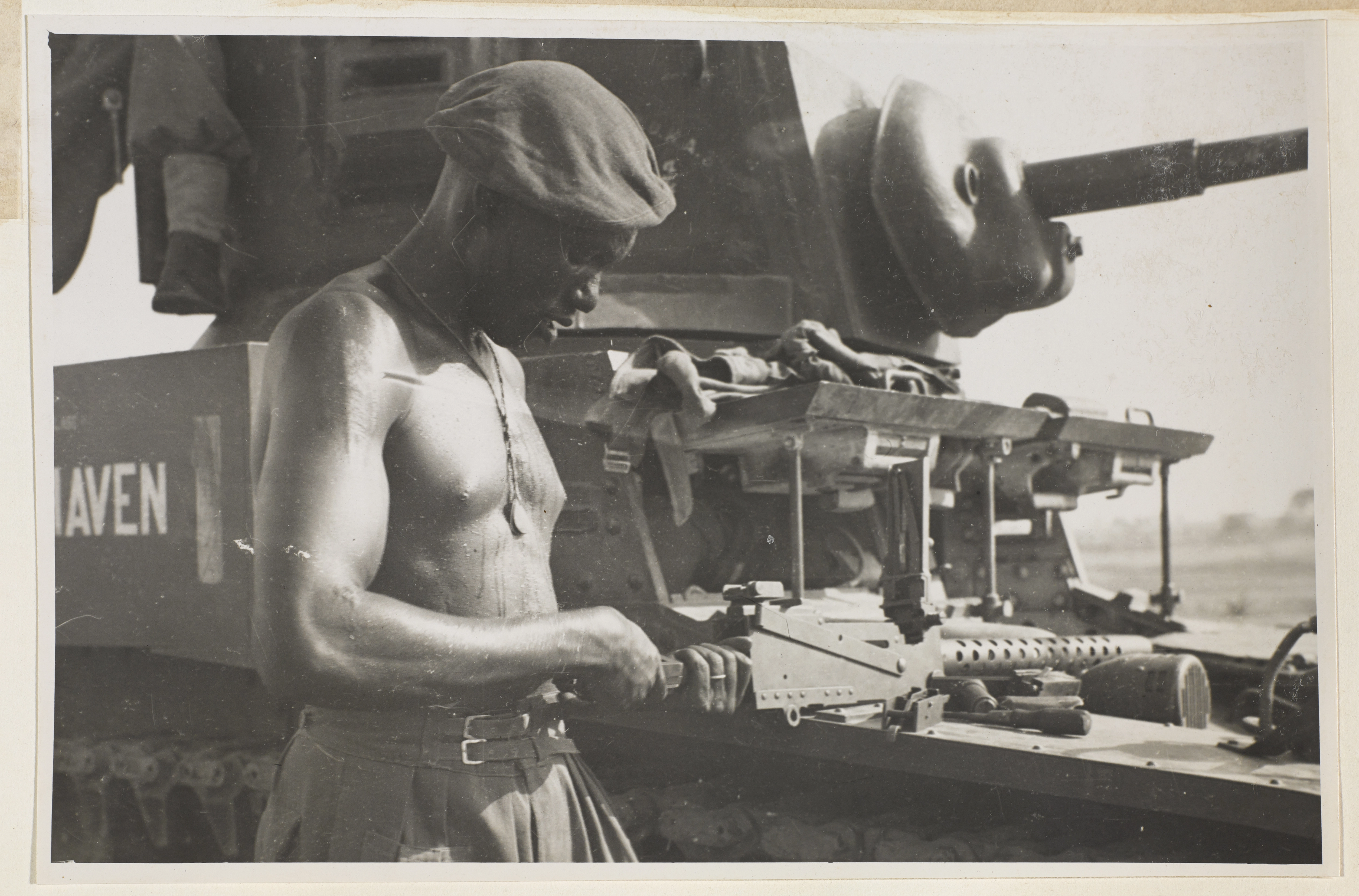 A soldier from the East African Reconnaissance Regiment, checking a machine-gun, Burma
