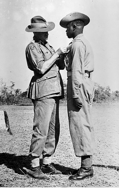 Lieutenant-General Sir William Slim awarding the Military Medal to Sergeant Jilalo Gafo, 11th East African Division