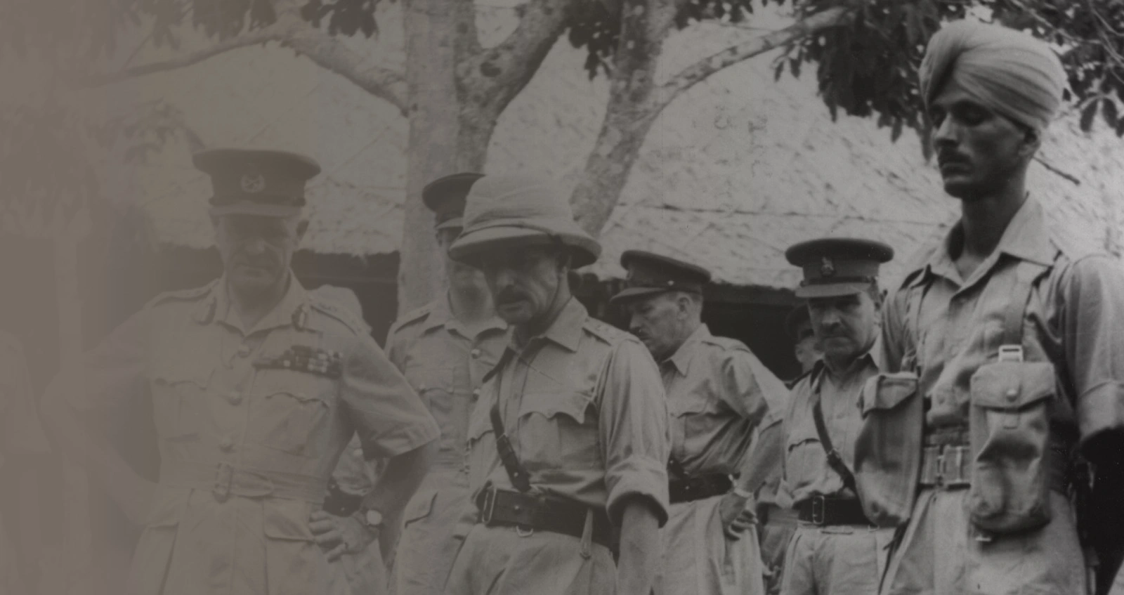 Lieutenant-General Sir William Slim, 14th Army Commander, talking to an African gunner