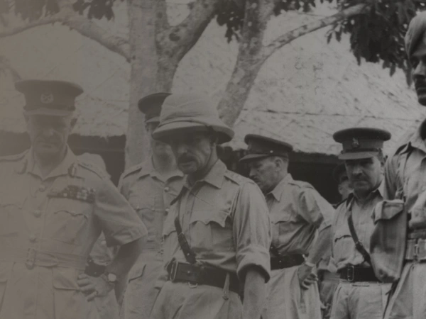 Lieutenant-General Sir William Slim, 14th Army Commander, talking to an African gunner