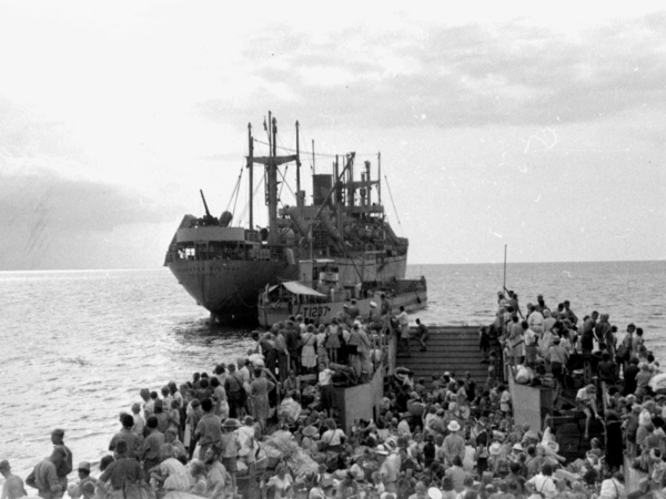 IWM A 31057 Repatriated prisoners of war evacuated to safer areas - scene shows the landing craft approaching the merchant ship