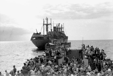 IWM A 31057 Repatriated prisoners of war evacuated to safer areas - scene shows the landing craft approaching the merchant ship