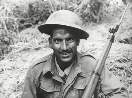 A sharp shooter of the Indian Army, fighting in alliance with the British, poses with his rifle, at an unknown location in Burma, in March 1944