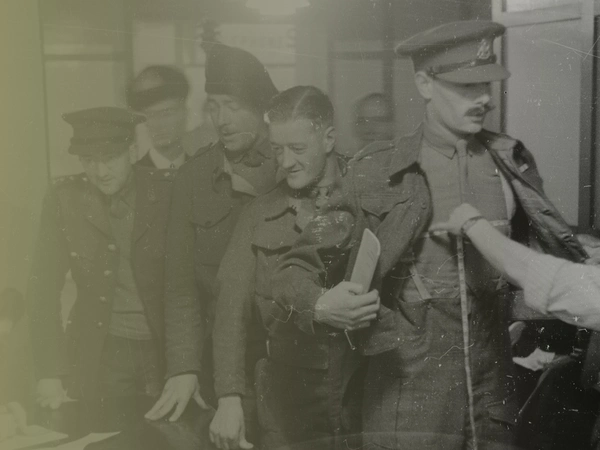 Soldiers being measured for civilian clothes at the clothing depot at Olympia, London after being demobbed from the army