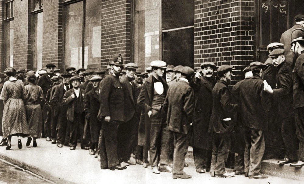 A queue of unemployed men waiting to 'sign on' for unemployment benefits