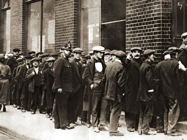 A queue of unemployed men waiting to 'sign on' for unemployment benefits