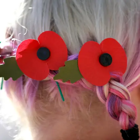 A volunteer wearing poppies in her hair