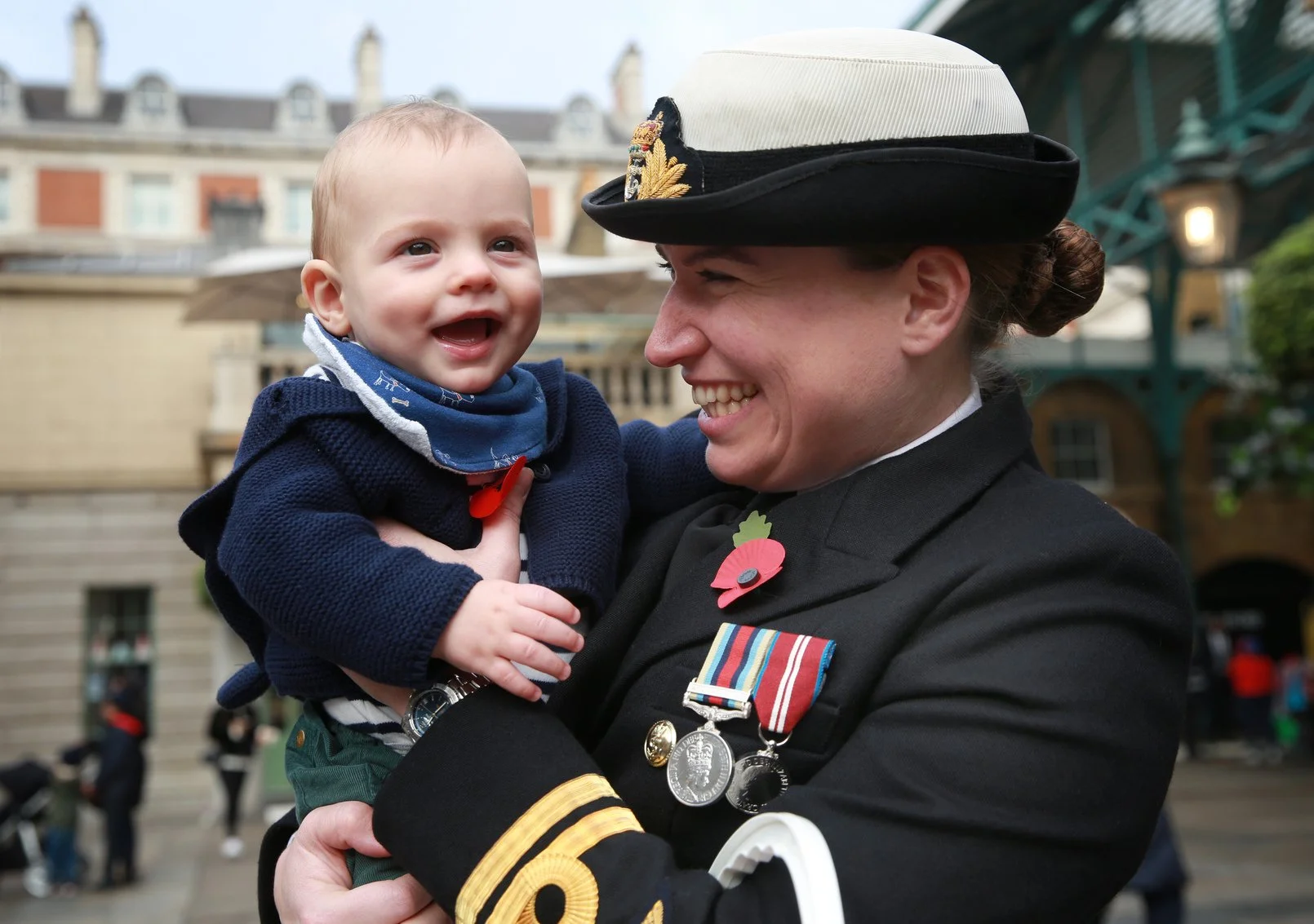 Poppy Appeal volunteer holding baby