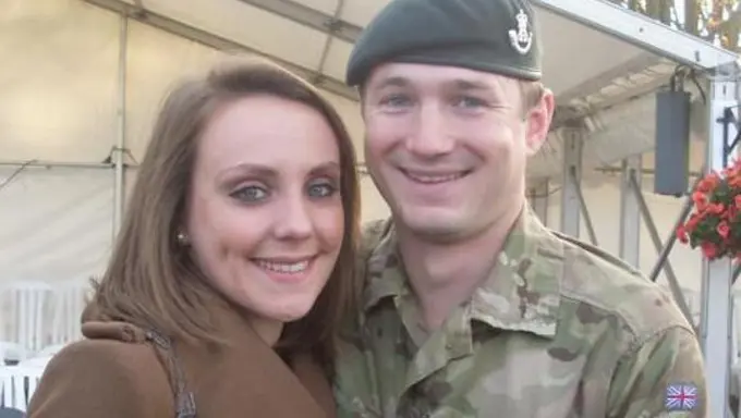 Victoria standing with her Husband Tom in uniform