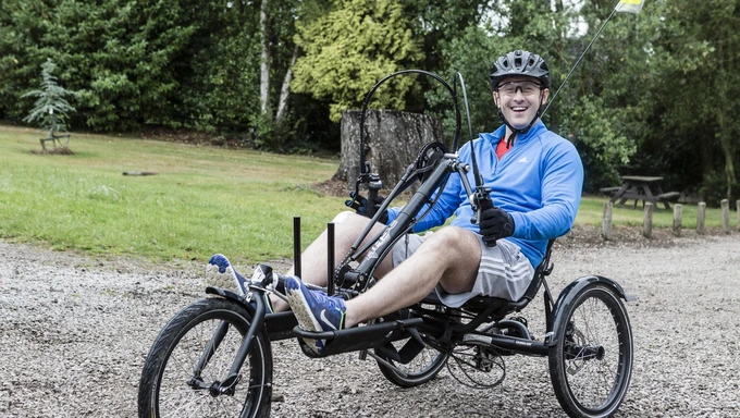 Man on wheelchair adaptive bike at Battle Back Centre