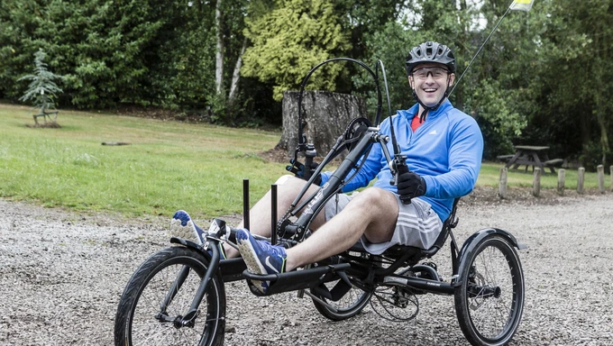 Wheelchair adaptive bike at Battle Back Centre Man on wheelchair adaptive bike at Battle Back Centre