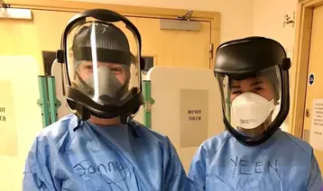 Apassara at work with a colleague in PPE