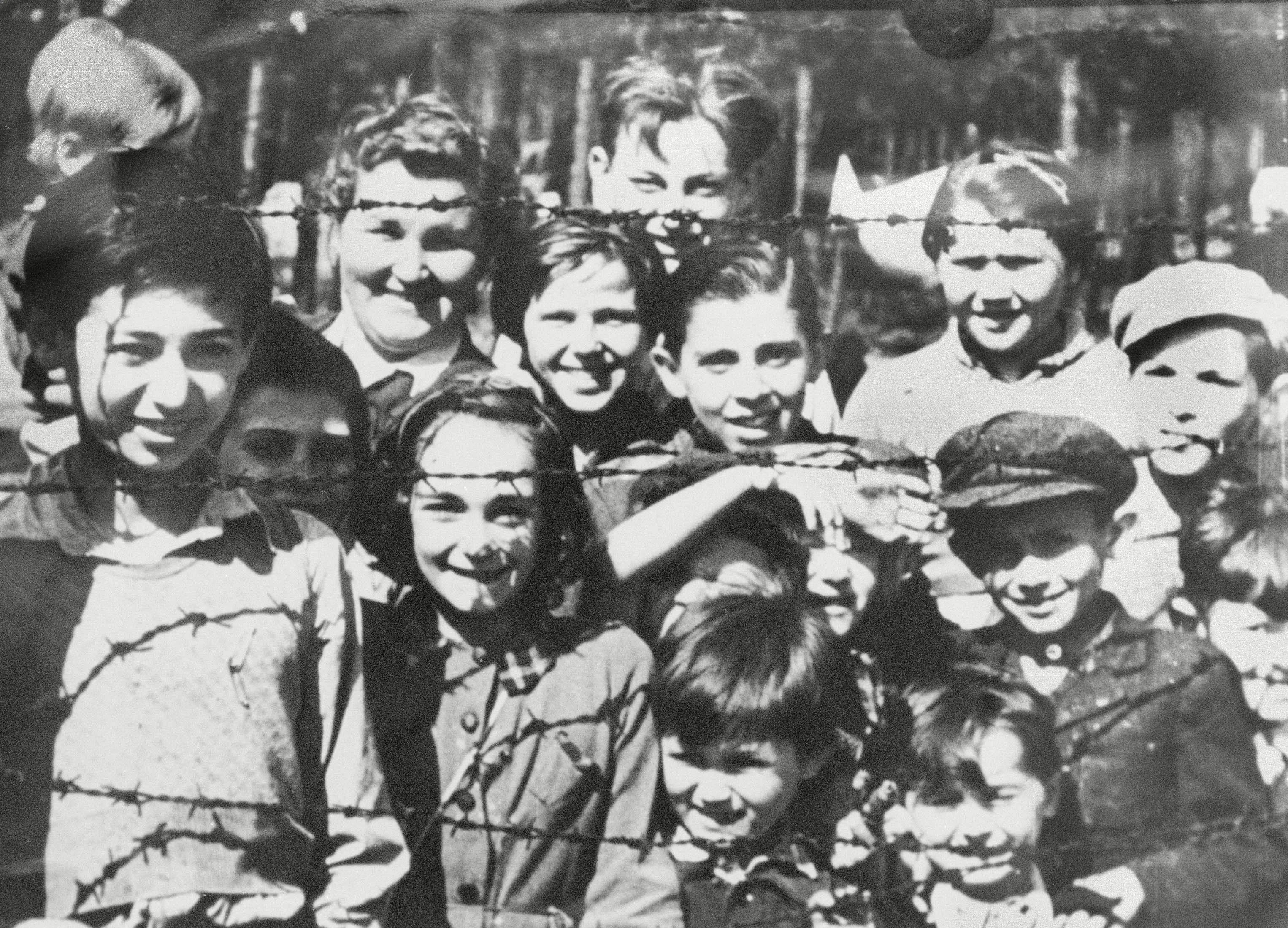 Children behind barbed wire at Bergen Belsen concentration camp