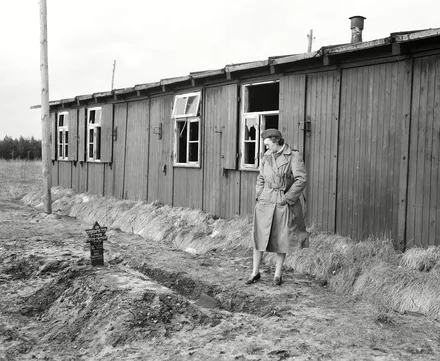 Woman looking at a grave in Bergen Belsen after the camp had been liberated