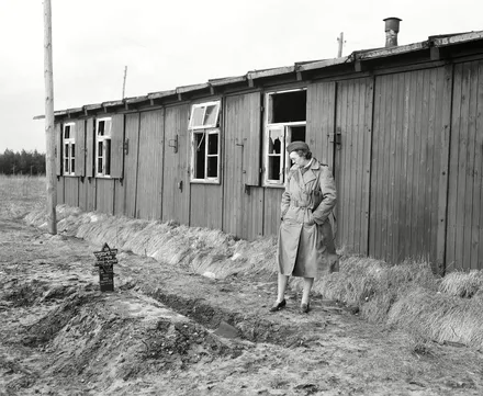 Woman looking at grave in the Belsen concentration camp Woman looking at a grave in Bergen Belsen after the camp had been liberated