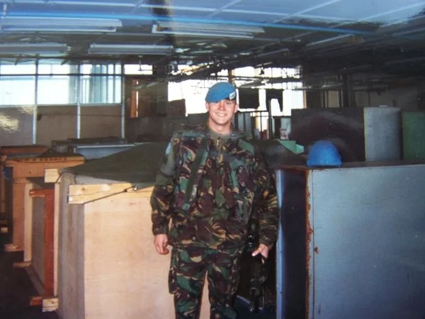 Matt standing in his uniform in Bosnia.