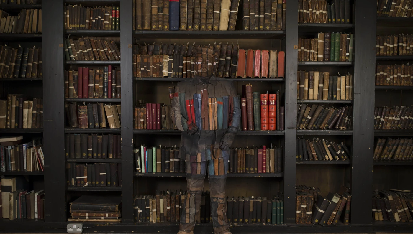 stories_count_them_in_frank_simpson Veteran Frank Simpson painted in front of a book case
