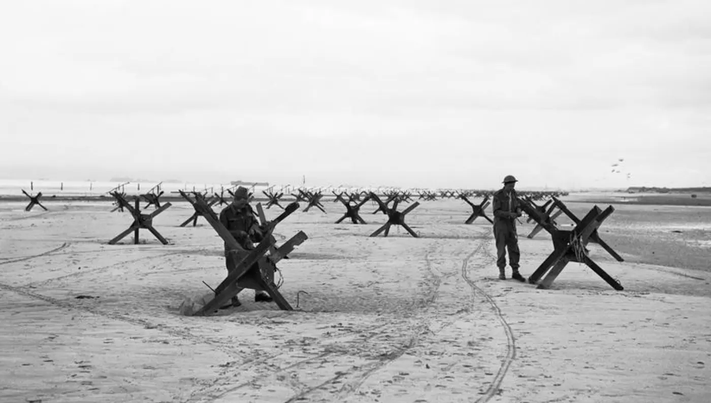 Royal Navy Commandos preparing to demolish beach obstacles designed to hinder the advance of an invading army.
