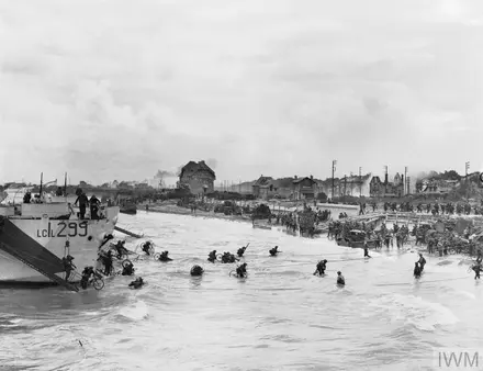 Troops of 9th Canadian Infantry Brigade disembarking with bicycles onto Nan White beach, 6 June 1944.