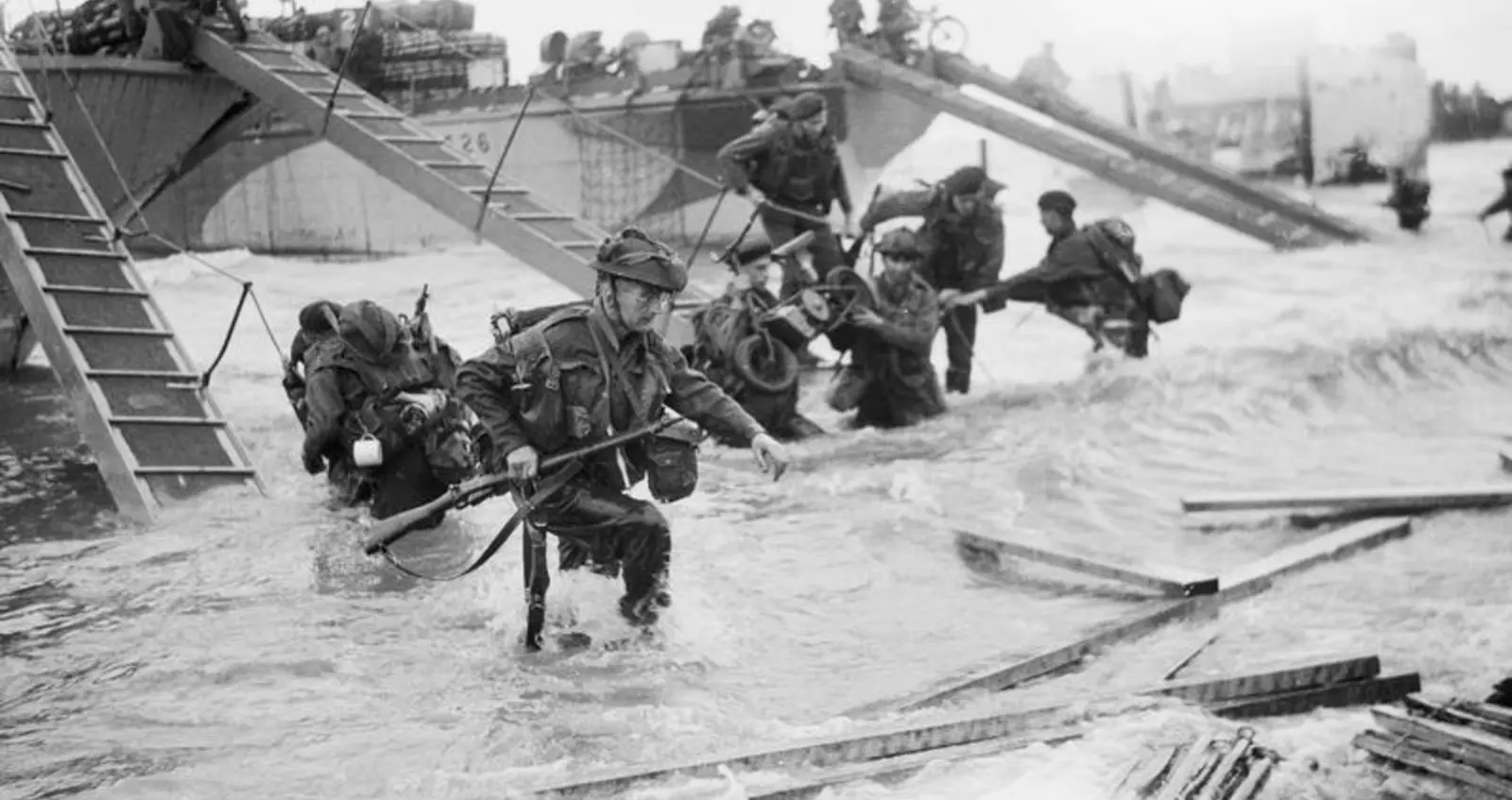B 5218 Royal Marine Commandos making their way onto the 'Nan Red' sector of Juno Beach, 6 June 1944.