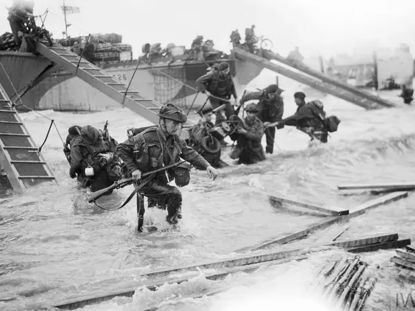 B 5218 Royal Marine Commandos making their way onto the 'Nan Red' sector of Juno Beach, 6 June 1944.