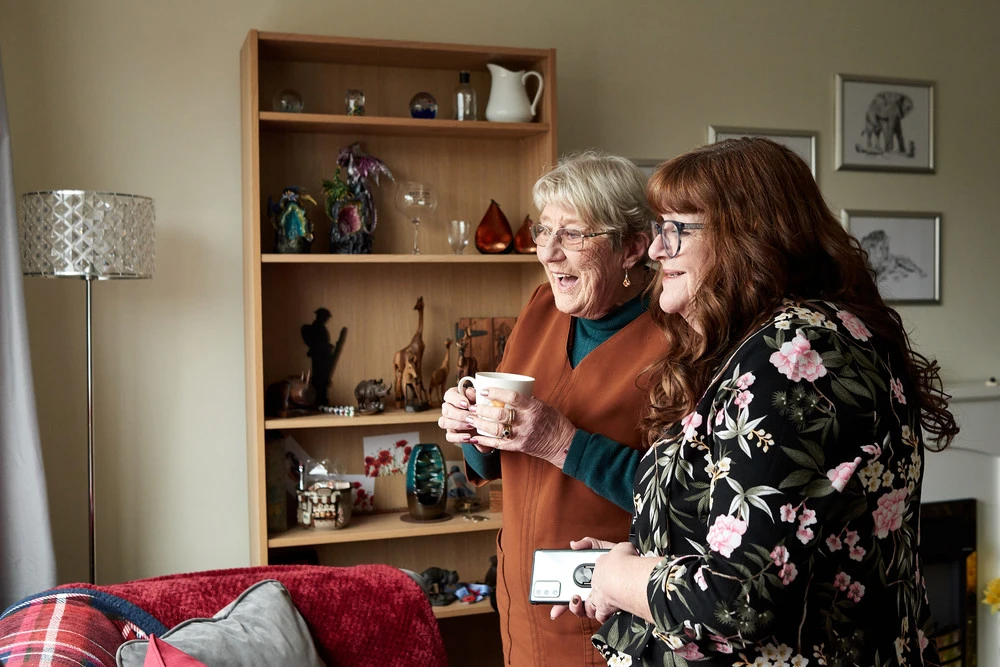 Dorothy Weir and Admiral Nurse Helen Buckley looking out of window