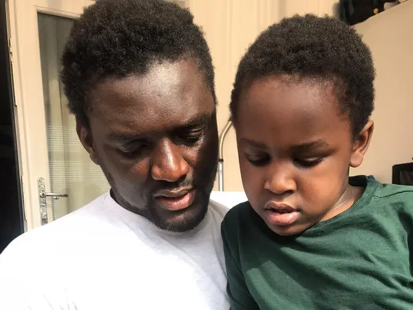Emmanuel with his son Chissey