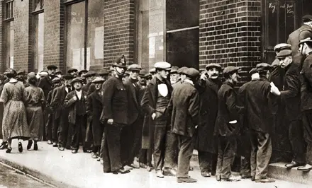 A queue of unemployed men waiting to sign on after the war
