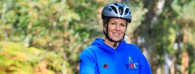 Heather standing with her bike.