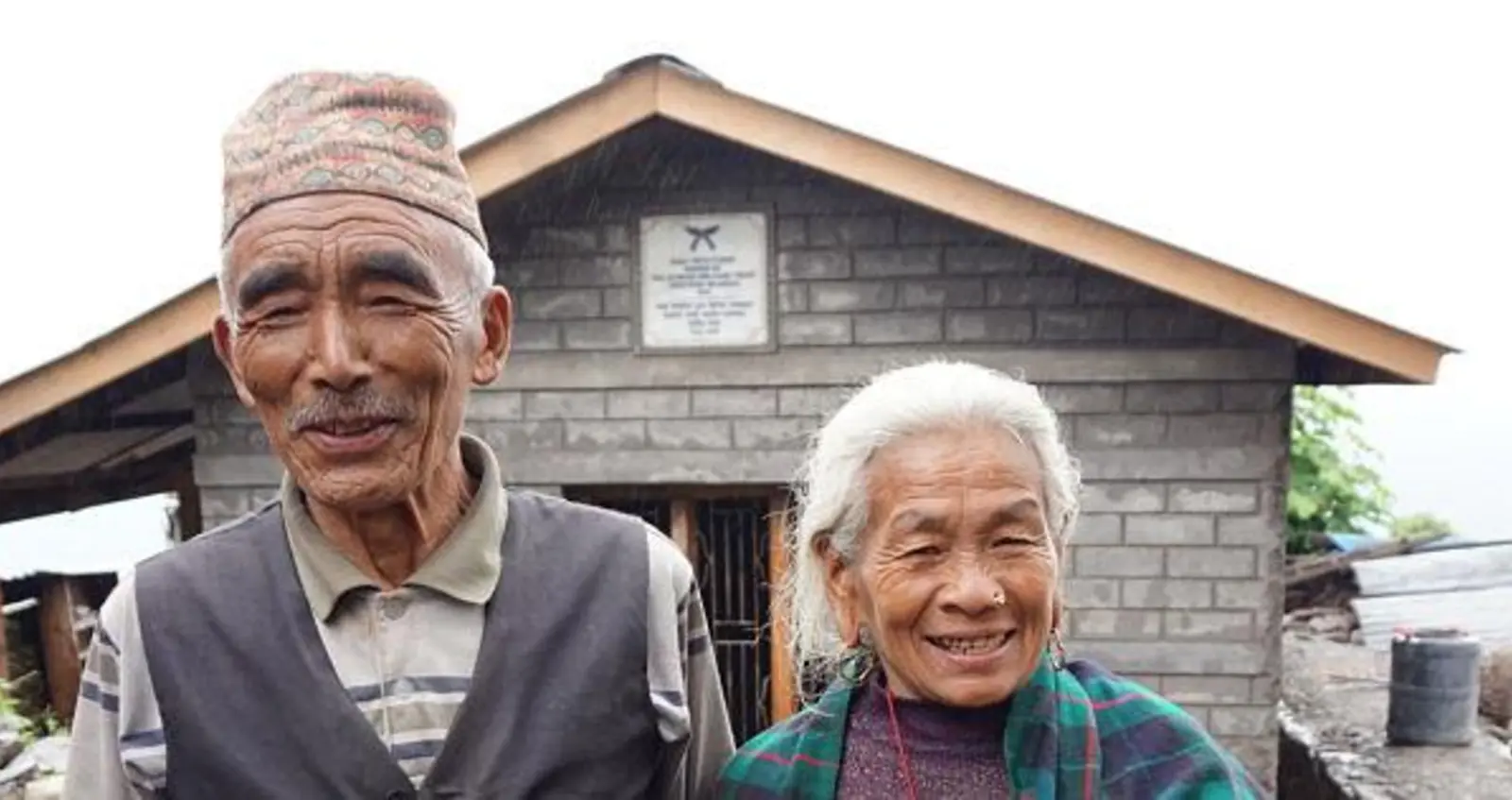  Baldhan and Budhini stood outside their newly build earthquake resistant home