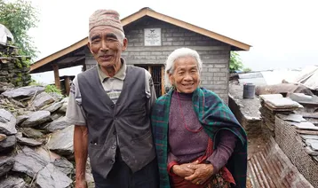  Baldhan and Budhini stood outside their newly build earthquake resistant home