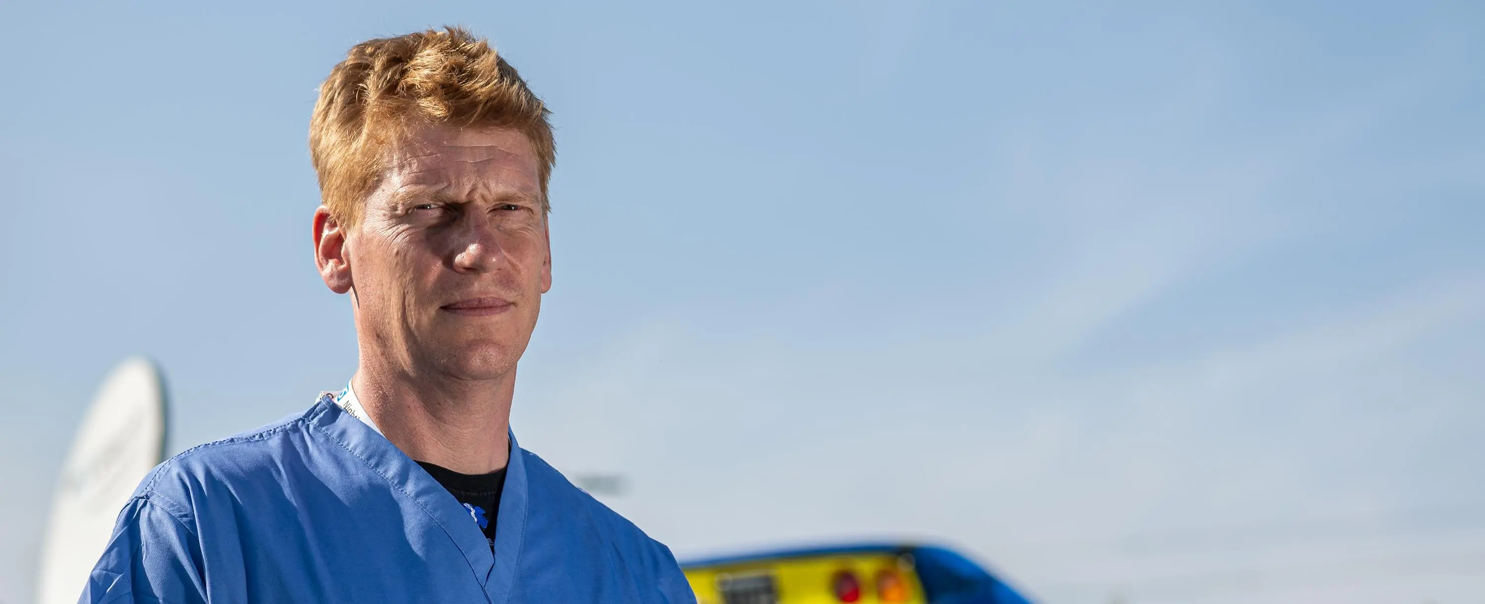 Harvey Pynn in front of an ambulance