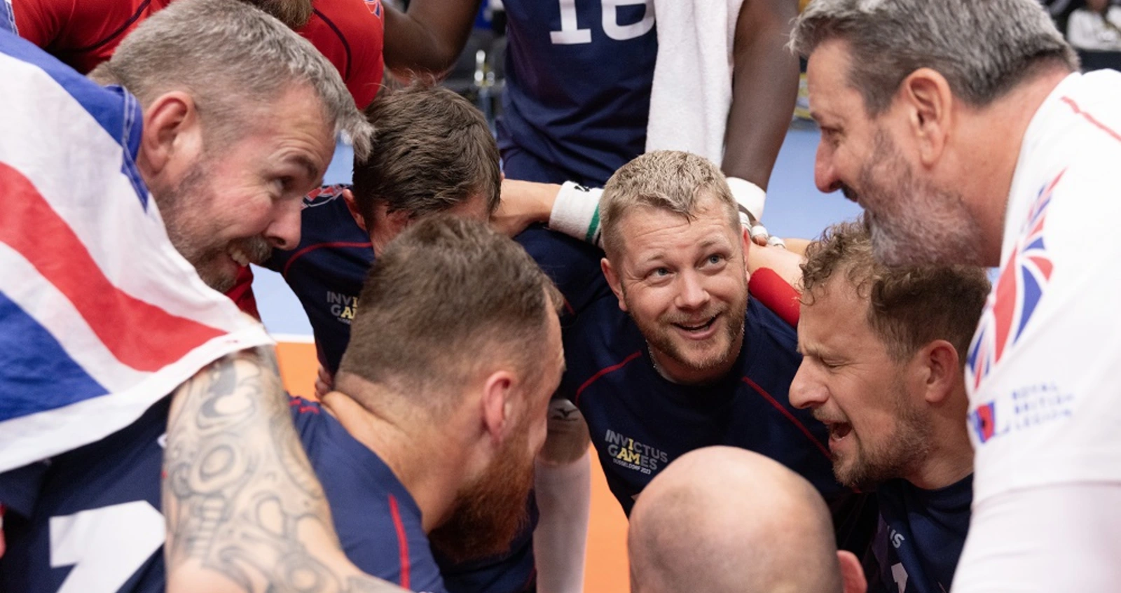 Steve Hooper talking to his coach at the Invictus Games Steve Hooper in team huddle at Invictus Games