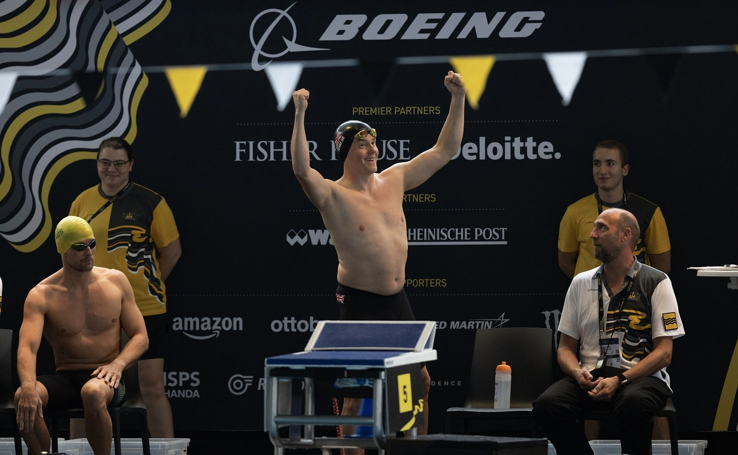 Charlie Charles raising his hands to the crowd at the Invictus Games before a swimming heat