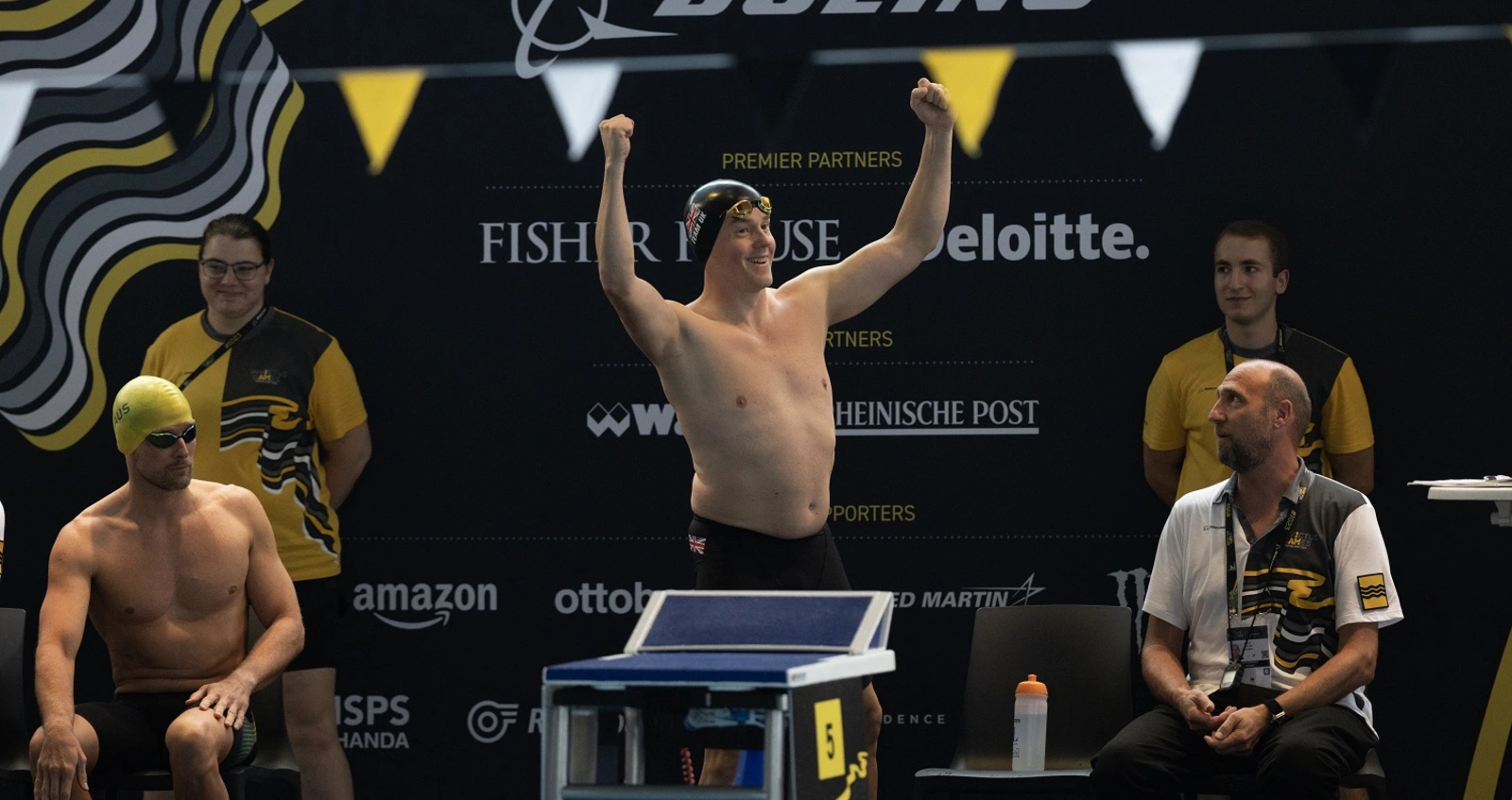Charlie Charles raising his hands to the crowd at the Invictus Games before a swimming heat
