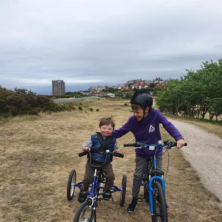 Jamie and Leo Jamie on his trike alongside his brother
