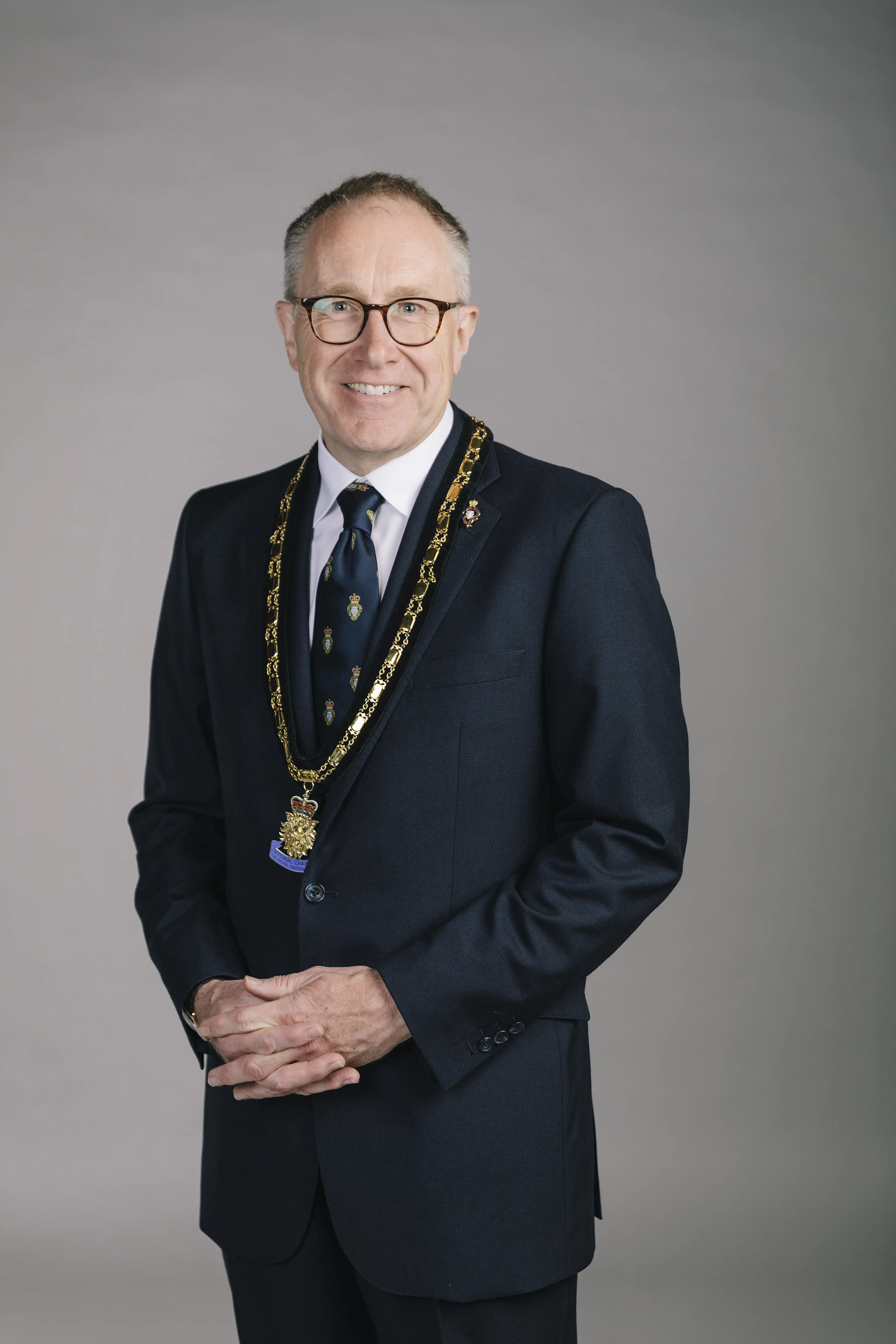 Portrait photograph of Jason Coward wearing a medallion