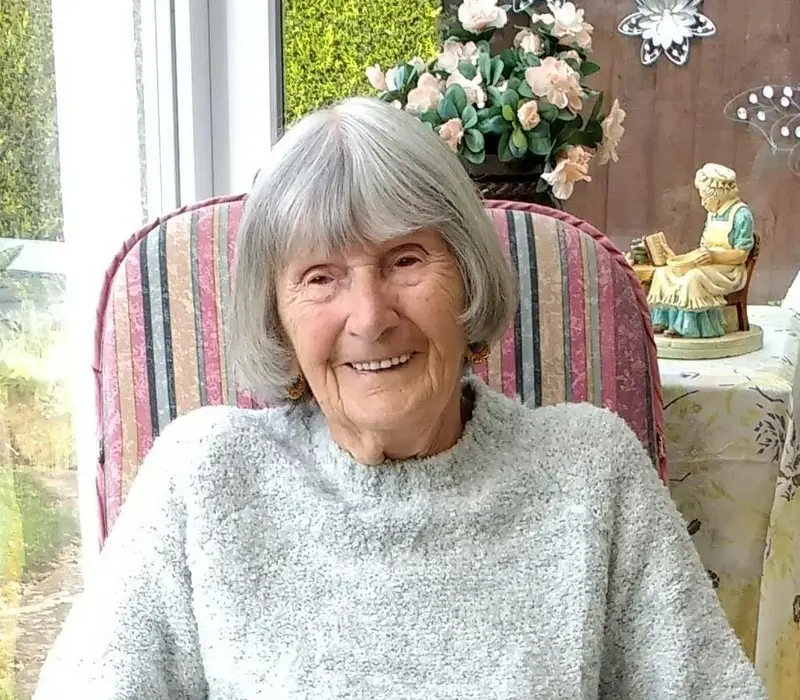 Joan Hall sitting in her conservatory